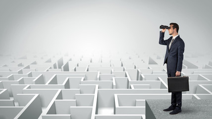Wall Mural - businessman standing on maze and looking forward to the future concept