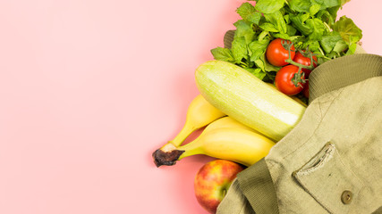 Healthy eating and zero waste concept. Free plastic shopping. Canvas bag with food on pink background, copy space. 16:9 banner format. 