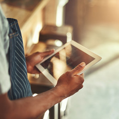 Wall Mural - Cafe owner holding digital tablet in hands