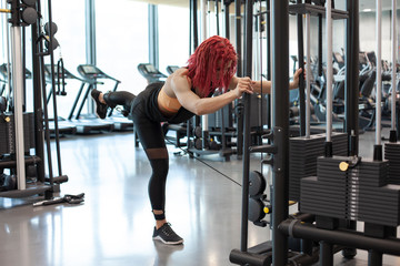 athletic girl trains in a fitness gym