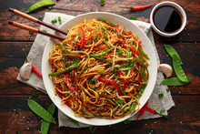 Chow Mein, Noodles And Vegetables Dish With Wooden Chopsticks