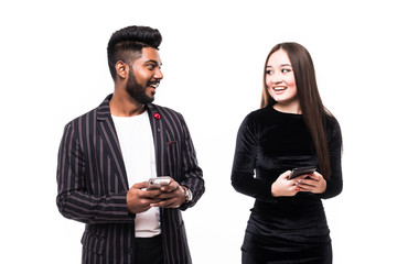 Wall Mural - Indian man and asian woman are watching their phones isolated on white background