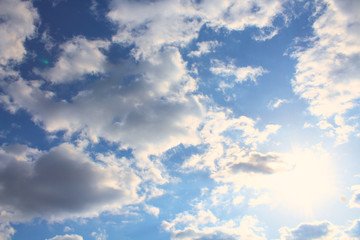 Wall Mural - Beautiful cumulus clouds and bright sun. Background. Landscape.