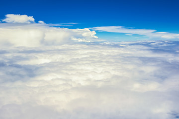 Wall Mural - view of the sky clouds above the clouds from airplane window