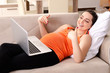 © Elnur - Young pregnant woman working at home