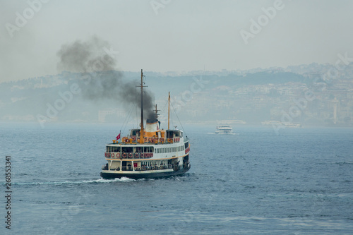 Fotografía Ferry boat sails on foggy weather and smoke coming from its chimney