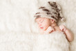 Newborn, baby sleeping in white bed, beautiful new born infant portrait in hat
