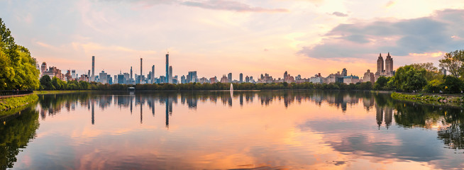 Sunset View of Manhattan skyline from Jacqueline Kennedy Onassis Reservoir in Central Park, reflection in water