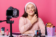 © sementsova321 - Portrait of smiling adorable female posing in front of camera, holding professional brush, applying foundation,looking at camera, having box with cosmetics and tools for makeup. Beauty concept.