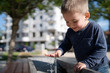 © Miljan Živković - Little boy at the public fountain playing with water drinking in summer sunny day