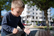 © Miljan Živković - Little boy at the public fountain playing with water drinking in summer sunny day