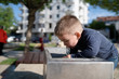 © Miljan Živković - Little boy at the public fountain playing with water drinking in summer sunny day thirsty refreshment