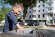 © Miljan Živković - Little boy at the public fountain playing with water drinking in summer sunny day