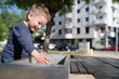 © Miljan Živković - Little boy at the public fountain playing with water drinking in summer sunny day