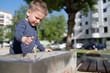 © Miljan Živković - Little boy at the public fountain playing with water drinking in summer sunny day