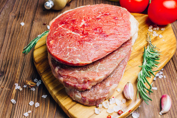 Fresh raw Black Angus beef steak on wooden board