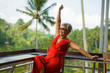 © TheVisualsYouNeed - attractive and happy Asian Indonesian middle aged woman with grey hair relaxed chilling cheerful and carefree and tropical holidays resort enjoying Summer getaway