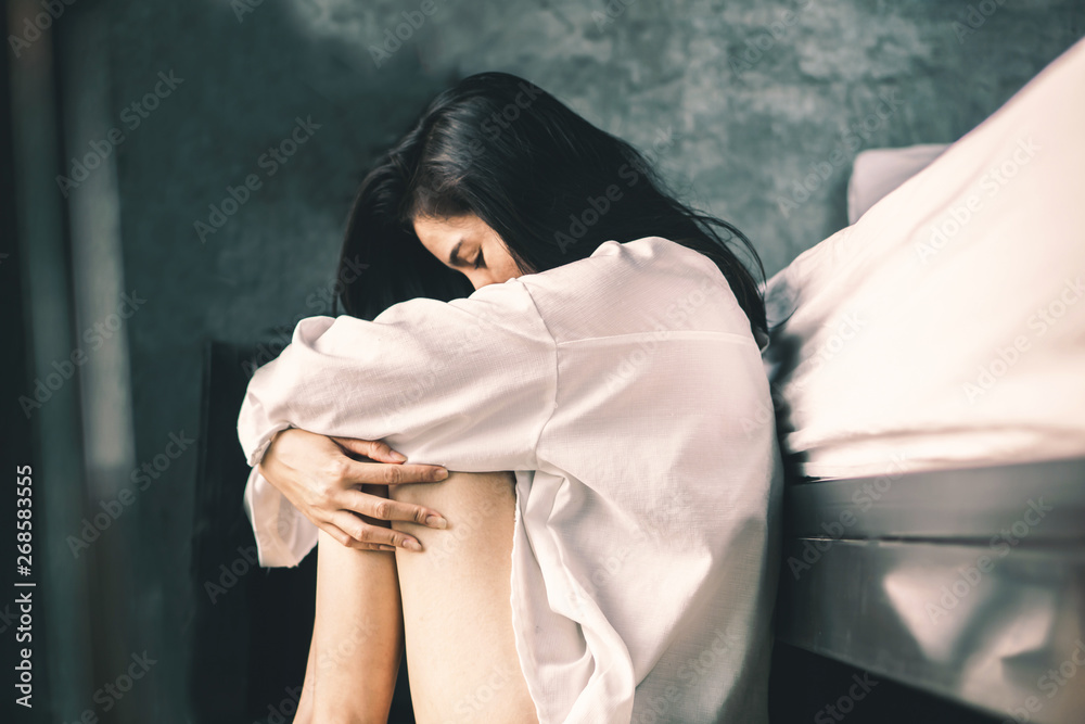 depress Asian woman sitting in bedroom feeling lonely and sad  - obrazy, fototapety, plakaty 