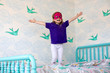 © Adam Hester - A toddler aged girl having fun and jumping on the bed in her bedroom.