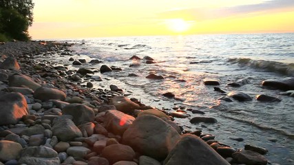 Wall Mural - Beautiful bright sunset on the shore of Lake Baikal on a warm July evening. Summer landscape 