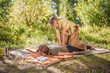 © Mr. Prof - Two women give each other massages out in the forest.