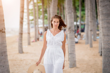 Wall Mural - Beautiful woman on the beach at sunset.