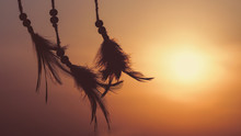 Blurred Image, Dream Catcher Native American In The Wind And Blurred Bright Light Background, Hope And   Dream Concepts