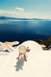 © Netfalls - Luxury travel vacation woman looking at view on Santorini island