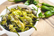 Roasted Padron Green Peppers in White Bowl. Pimientos de Padron.