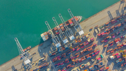 Container ship in export and import business logistics and transportation. Cargo and container box shipping to harbor by crane. Water transport International. Aerial view and top view.