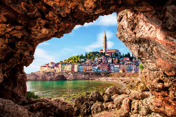 Unusual view with old clock towe in Piran through a rock hole. the tourist center of Slovenia. popular tourist attraction. Wonderful exciting places.