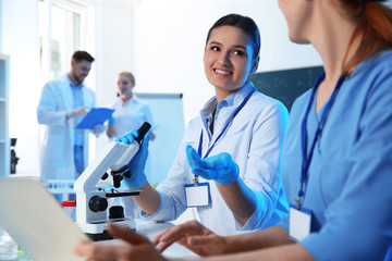 Poster - Group of scientists working in modern chemistry laboratory