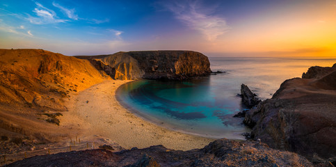 Wall Mural - romantic sunset over the beautiful, natural and sandy beach of papagayo on lanzarote