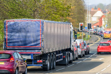 Lorry Truck Stuck In Busy Traffic On Road In British Town At Noon Time