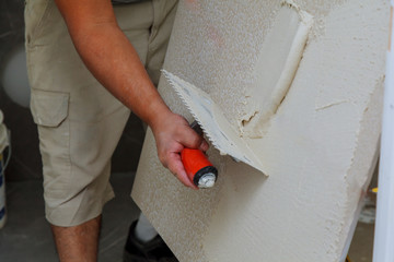 Wall Mural - Spreading wet mortar before applying tiles on bathroom floor