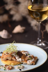 Canvas Print - fried fish fillet with a sauce on the background of a glass of wine