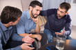 © JackF - Three anxious men discussing on sofa