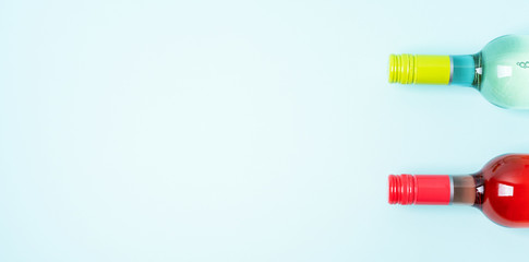 Wall Mural - Colorful bottle caps of white and rose wine bottles on turquoise background. Minimal abstract colorful layout concept of summer time alcohol beverage. Long wide banner.