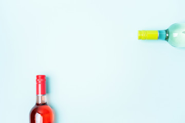 Wall Mural - Screw bottle foil caps in different bright colors of white and rose wine bottles on blue background with copy space. Minimal abstract colorful mockup concept of alcohol beverage. Flat lay.