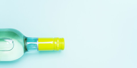 Wall Mural - Screw bottle foil caps in different bright colors of white and rose wine bottles on blue background with copy space. Minimal abstract colorful mockup concept of alcohol beverage. Flat lay.