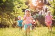 © davit85 - Large group of kids, friends boys and girls running in the park on sunny summer day in casual clothes .