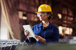 © Seventyfour - Waist up portrait of female worker using digital tablet while supervising production at plant, copy space