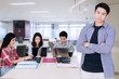 © Creativa Images - Male business leader stands in front of his partners