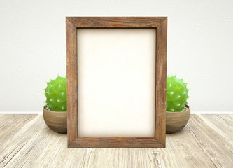 Mockup of wooden frame and green succulent plant in ceramic pot on wooden table