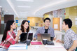 © Creativa Images - Young man explains financial report in the office