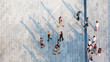 © ultramansk - group of people walk on across the pedestrian concrete landscape in the city street (Aerial top view)