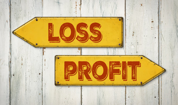 Direction signs on a wooden wall - Loss or Profit
