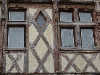 Wall Mural - old typical wooden window in the Loire Valley, France of a limestone facade house with wood beams