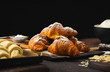 Breakfast croissant with chocolate on a dark stone background