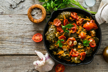 Traditional green, turkish and georgian food dolma on rustic wood background